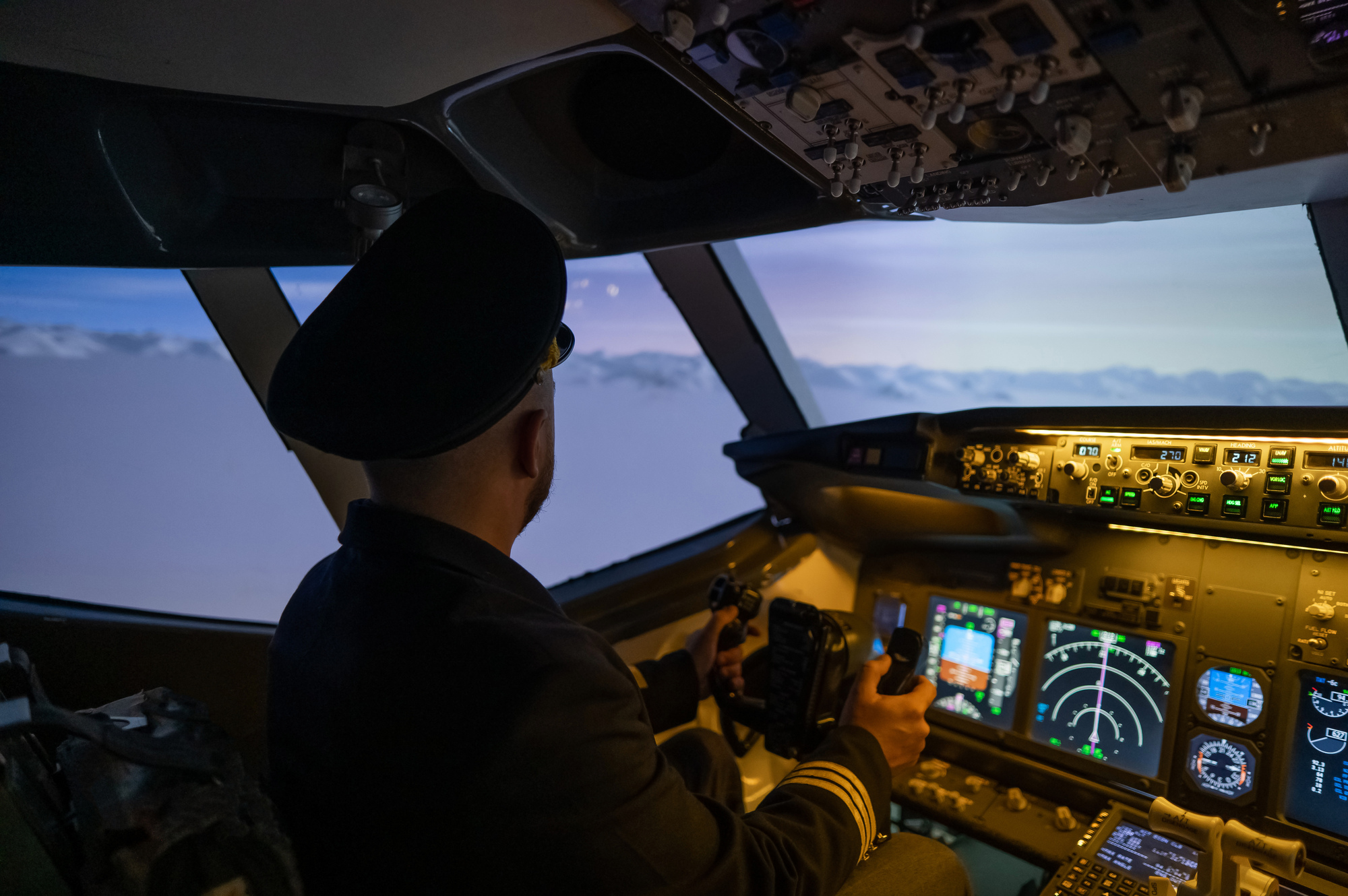 A man is studying to be a pilot in an aircraft simulator.